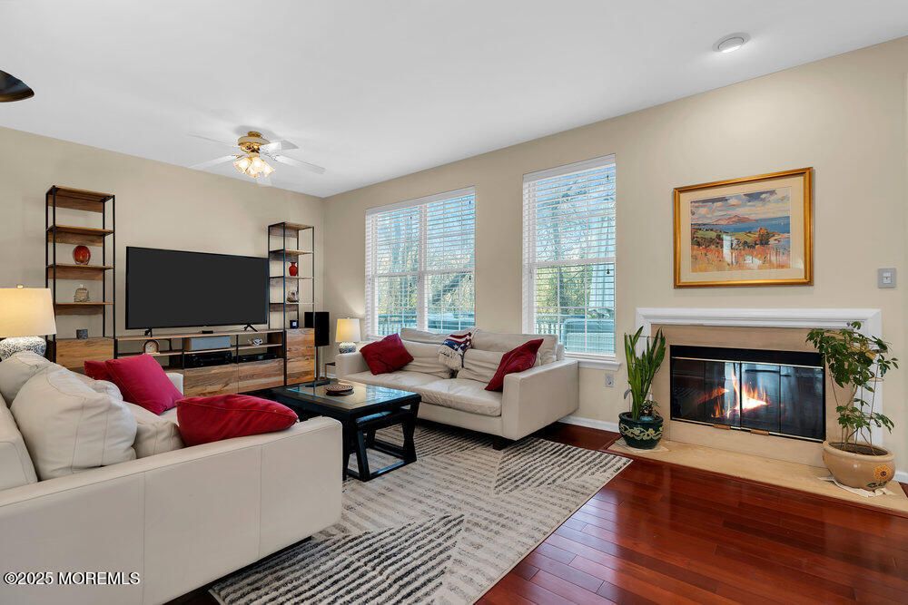 2 Blacksmith Pass Colts Neck, NJ 07722 - Photo 11 of 34 a living room with furniture a fireplace and a flat screen tv