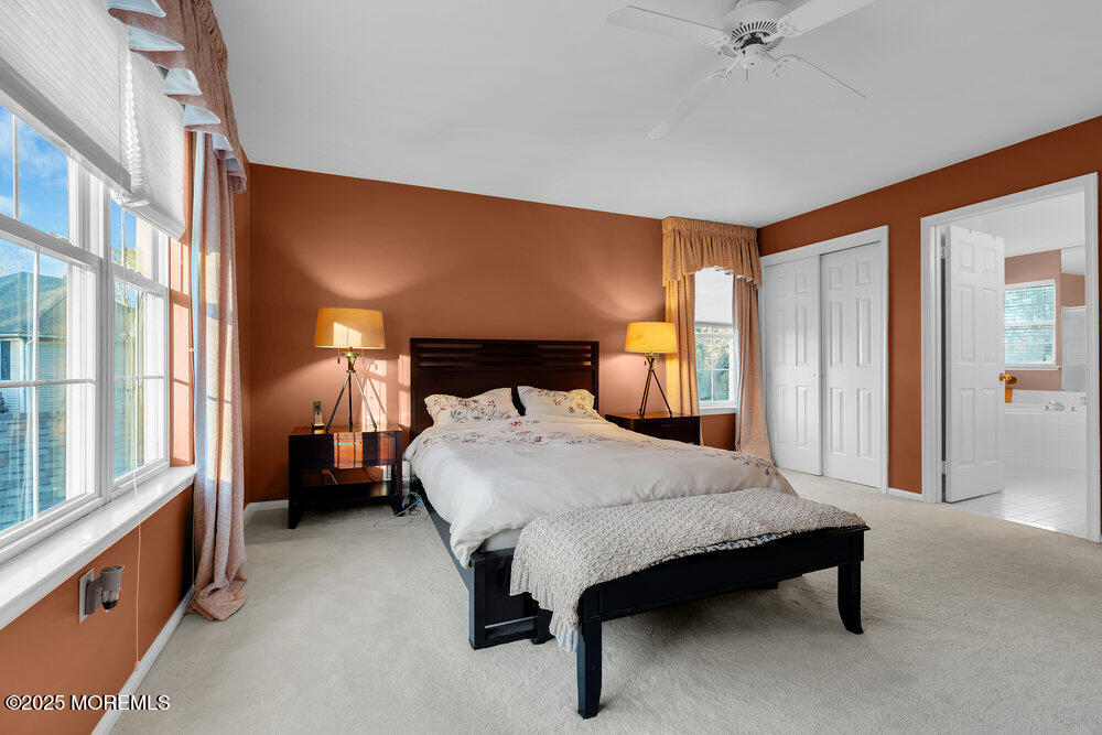 2 Blacksmith Pass Colts Neck, NJ 07722 - Photo 15 of 34 a spacious bedroom with a bed and a large window