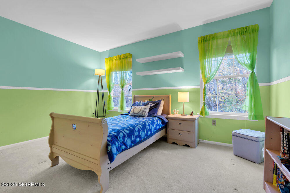 2 Blacksmith Pass Colts Neck, NJ 07722 - Photo 19 of 34 a bedroom with a bed and a chair