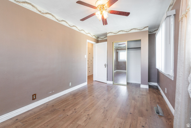 59 East Pinehurst Street Tooele, UT 84074 - Photo 11 of 22 Interior room featuring wood-finish flooring, a ceiling fan with light fixture, white baseboards, and a window with blinds
