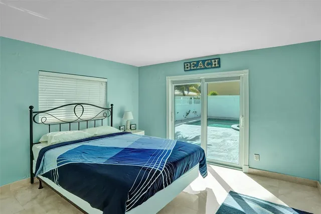 a bedroom with a bed and large mirror