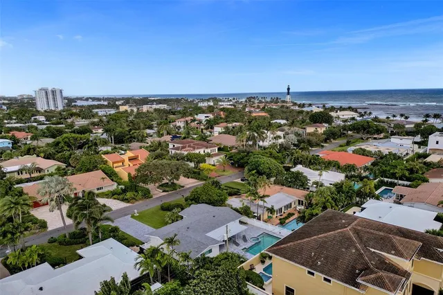 an aerial view of a house with a yard and garden