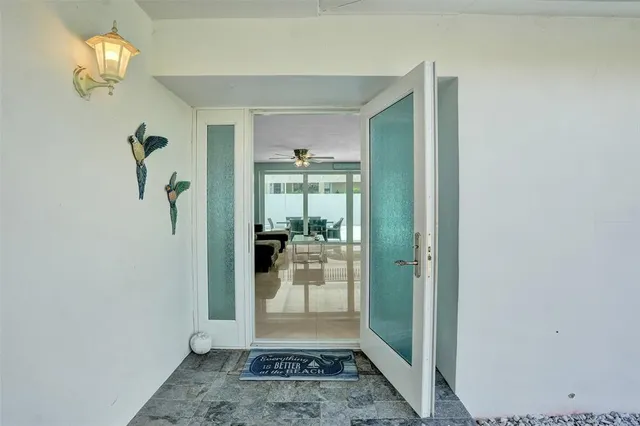 a view of a hallway view with wooden floor and a dining room