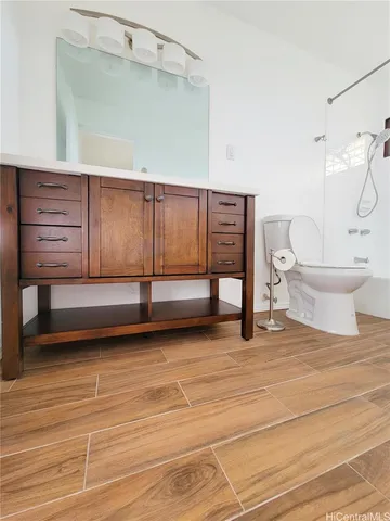 a bathroom with a toilet and a shower