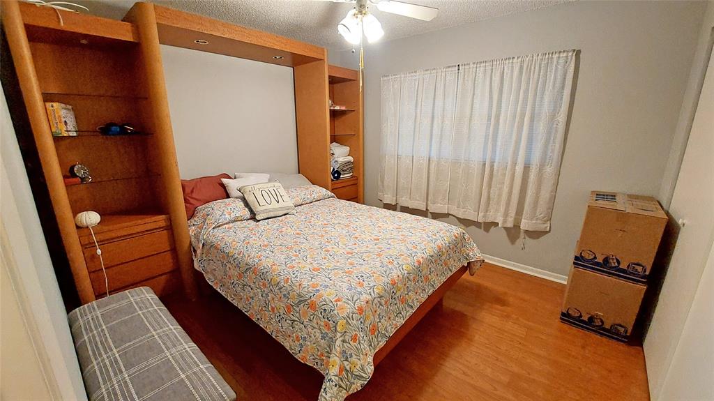 367 South Federal Highway, Unit C225 Deerfield Beach, FL 33441 - Photo 11 of 36 a bedroom with bed and wooden floor