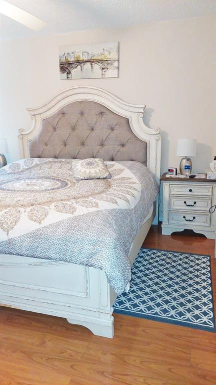 367 South Federal Highway, Unit C225 Deerfield Beach, FL 33441 - Photo 20 of 36 a bedroom with a bed and wooden floor