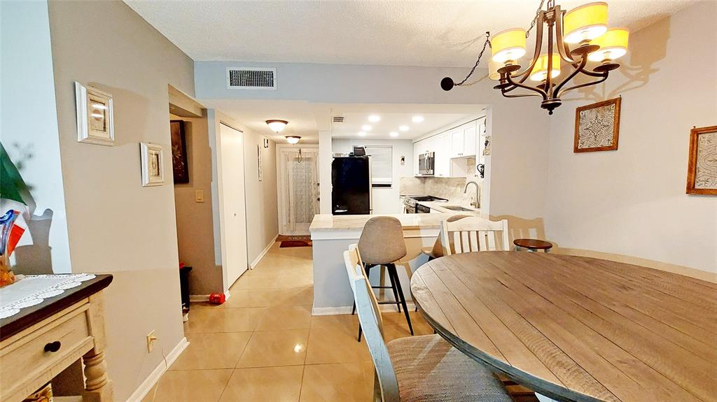 367 South Federal Highway, Unit C225 Deerfield Beach, FL 33441 - Photo 8 of 36 a view of a dining room with furniture