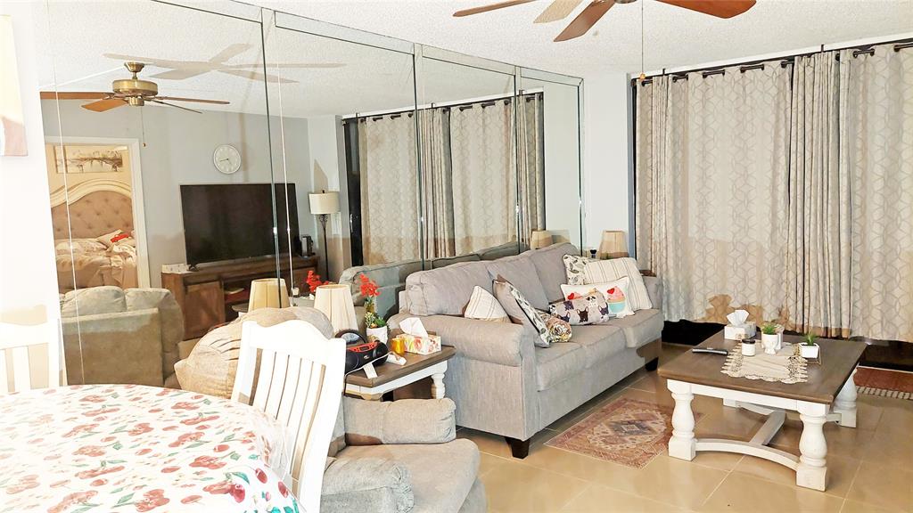 367 South Federal Highway, Unit C225 Deerfield Beach, FL 33441 - Photo 9 of 36 a living room with furniture and a flat screen tv