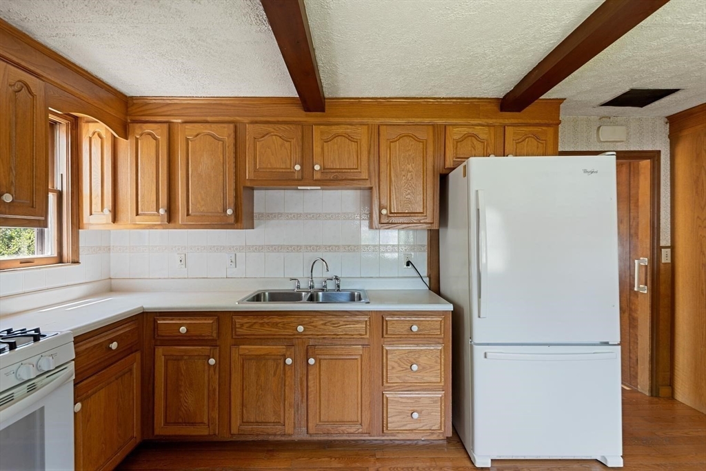 19 Butler Avenue Wakefield, MA 01880 - Photo 15 of 33 a kitchen with a refrigerator sink and cabinets