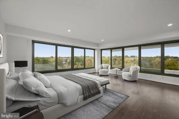 a large bedroom with bed and large windows