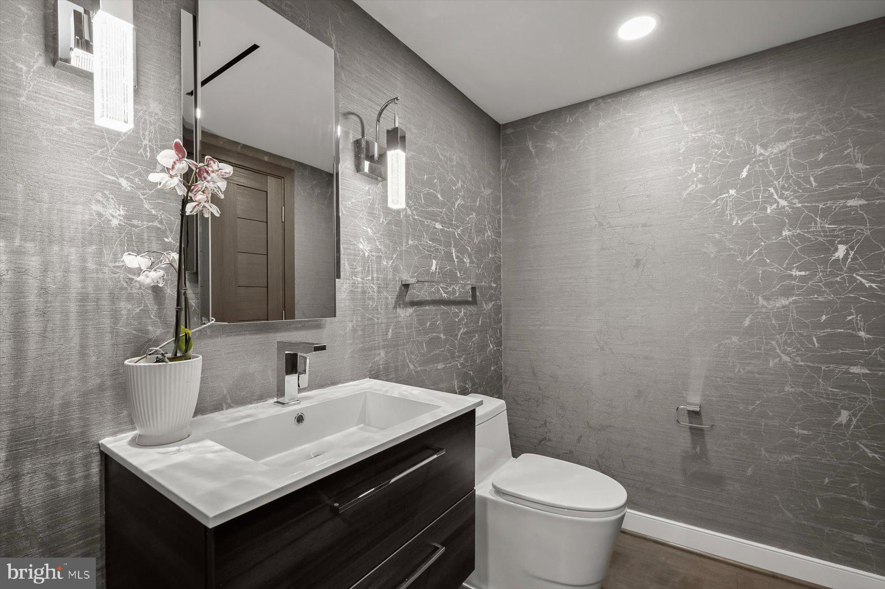 2501 M Street Northwest, Unit 612 Washington, DC 20037 - Photo 15 of 44 a bathroom with a sink toilet and mirror