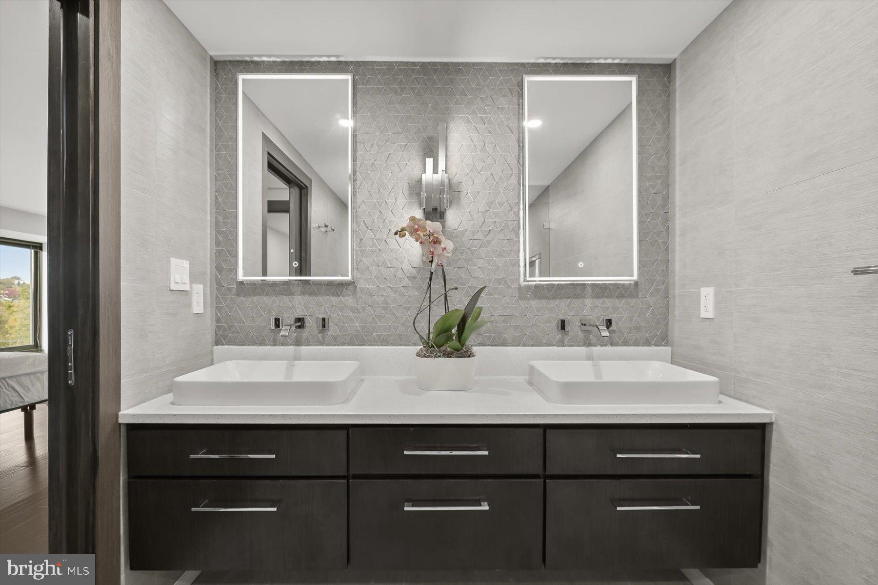 2501 M Street Northwest, Unit 612 Washington, DC 20037 - Photo 23 of 44 a bathroom with a sink vanity and a mirror