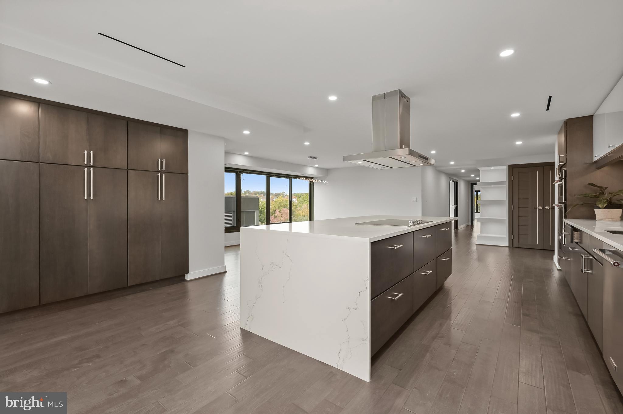 2501 M Street Northwest, Unit 612 Washington, DC 20037 - Photo 9 of 44 a large kitchen with stainless steel appliances granite countertop a large counter top and a wooden floors