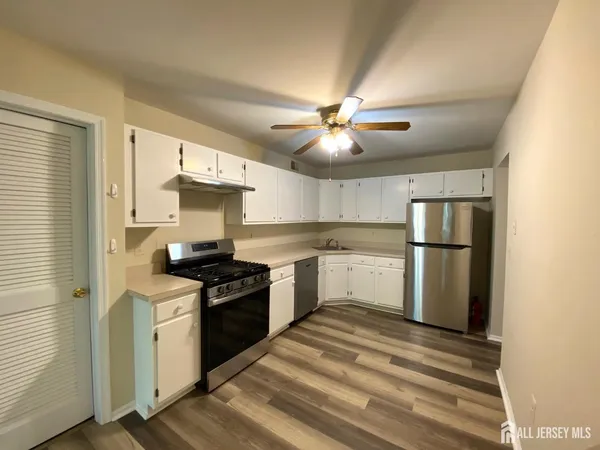 a kitchen with a stove and a refrigerator