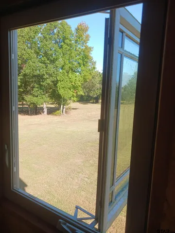 a living room with a couch and a clock on the wall