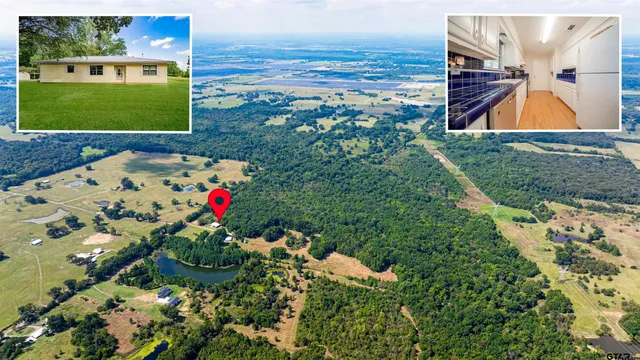 a bathroom with a toilet a sink a mirror and a window