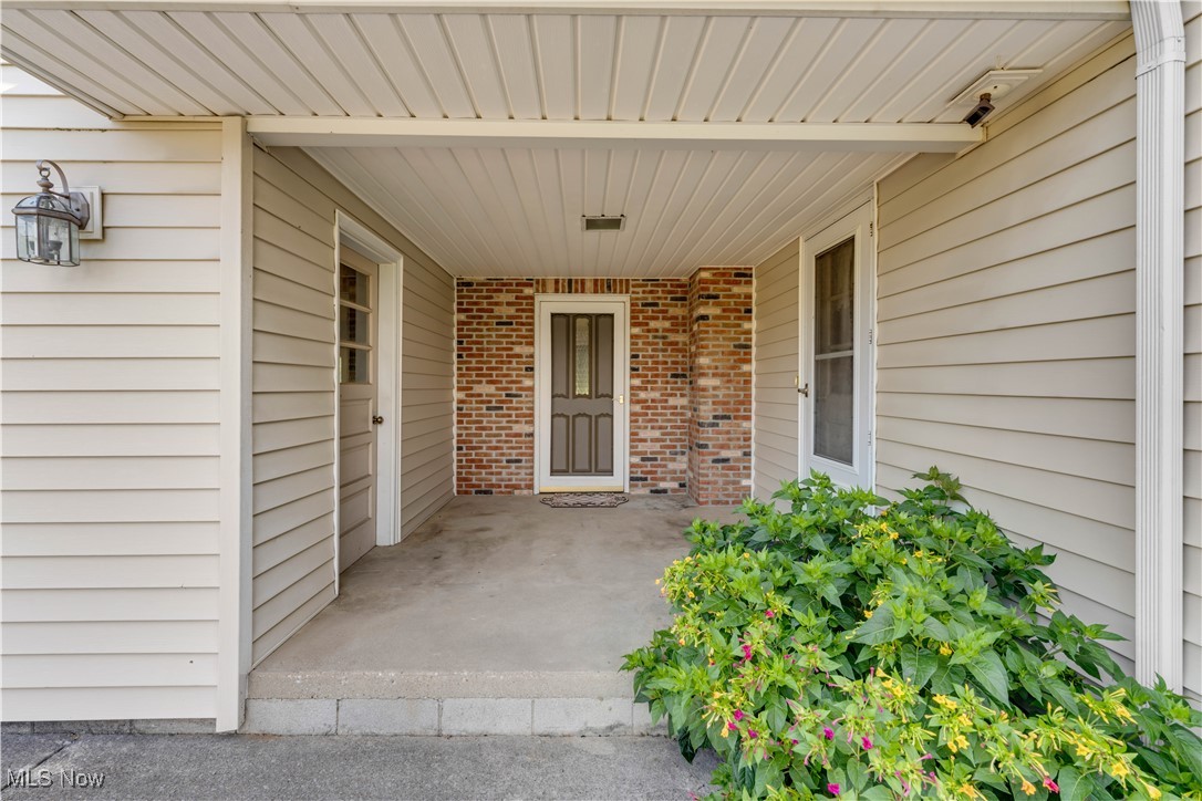 38450 Otten Road North Ridgeville, OH 44039 - Photo 16 of 45 View of exterior entry with brick siding and covered porch