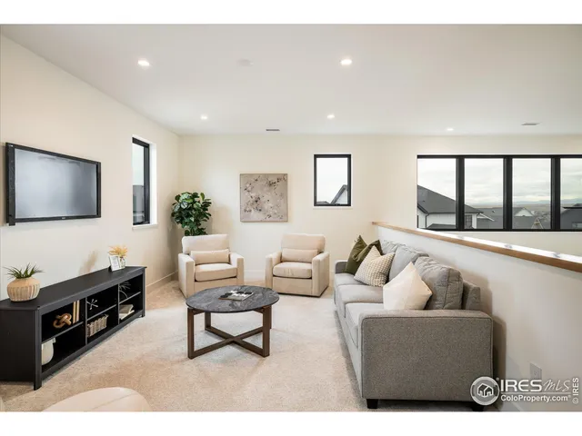 a bedroom with a bed lamp and a potted plant