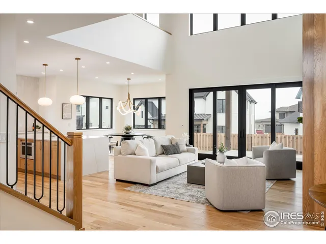 a living room with furniture a fireplace and a potted plant