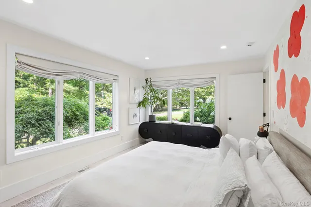 a room with a bed and a large window