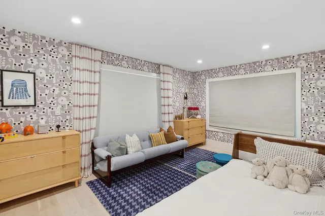 a bedroom with furniture and a wooden floor