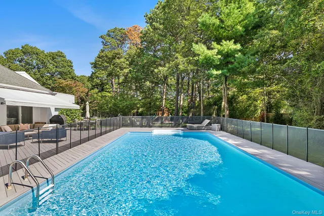 a view of backyard with swimming pool