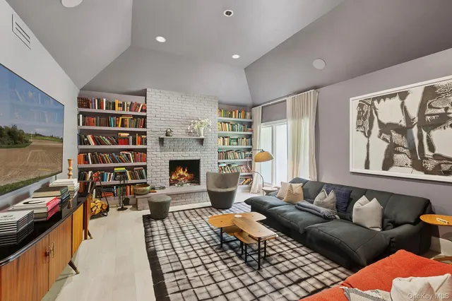 a living room with furniture fireplace and rug