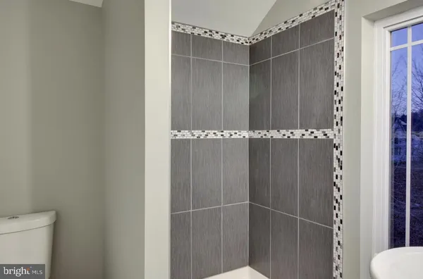 a view of a bathroom with a glass door and shower