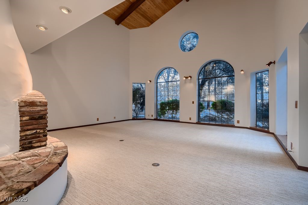 1 Quail Run Road Henderson, NV 89014 - Photo 8 of 82 Living room features high wood ceilings, multiple surrounding large windows