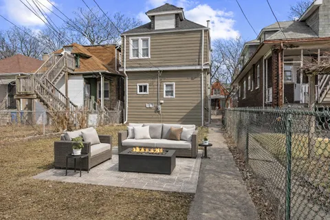 a view of a patio with couches chairs and wooden floor