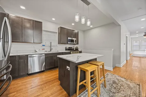 a kitchen with a sink appliances and cabinets