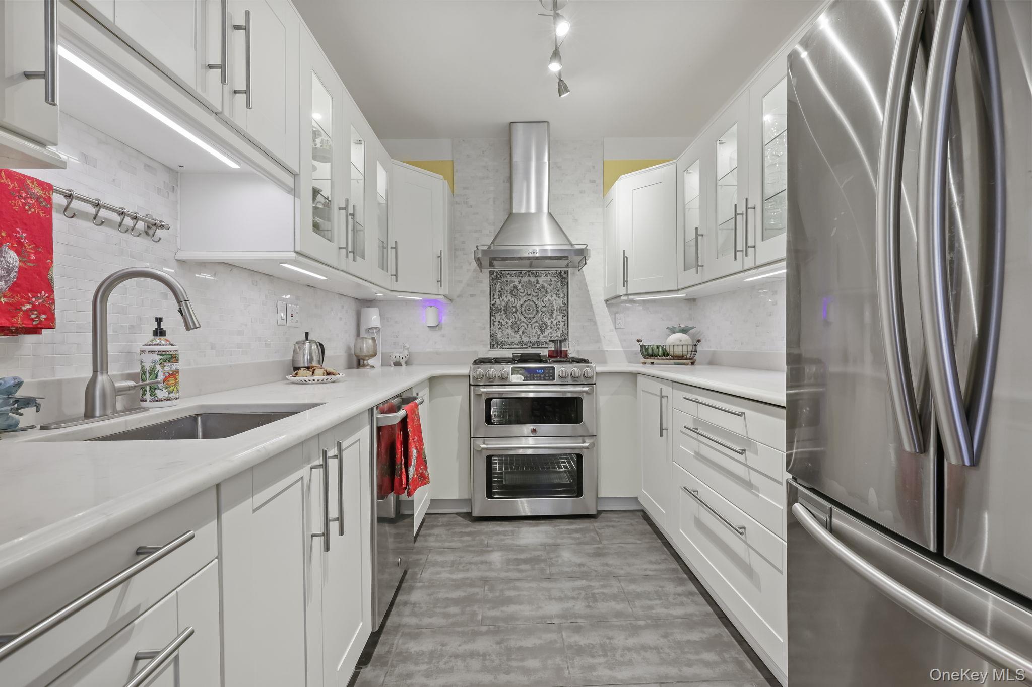 a kitchen with stainless steel appliances a sink cabinets and a counter top space