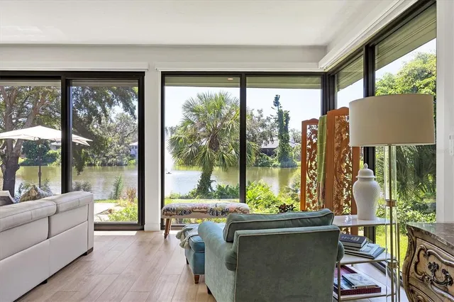 a living room with furniture and a floor to ceiling window