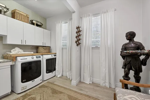 a kitchen with a stove and white cabinets