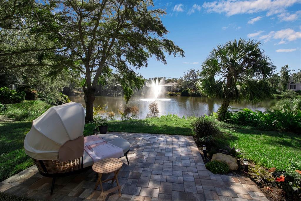 17 Bayhead Lane Osprey, FL 34229 - Photo 28 of 37 a view of a table and chairs in the patio next to a yard