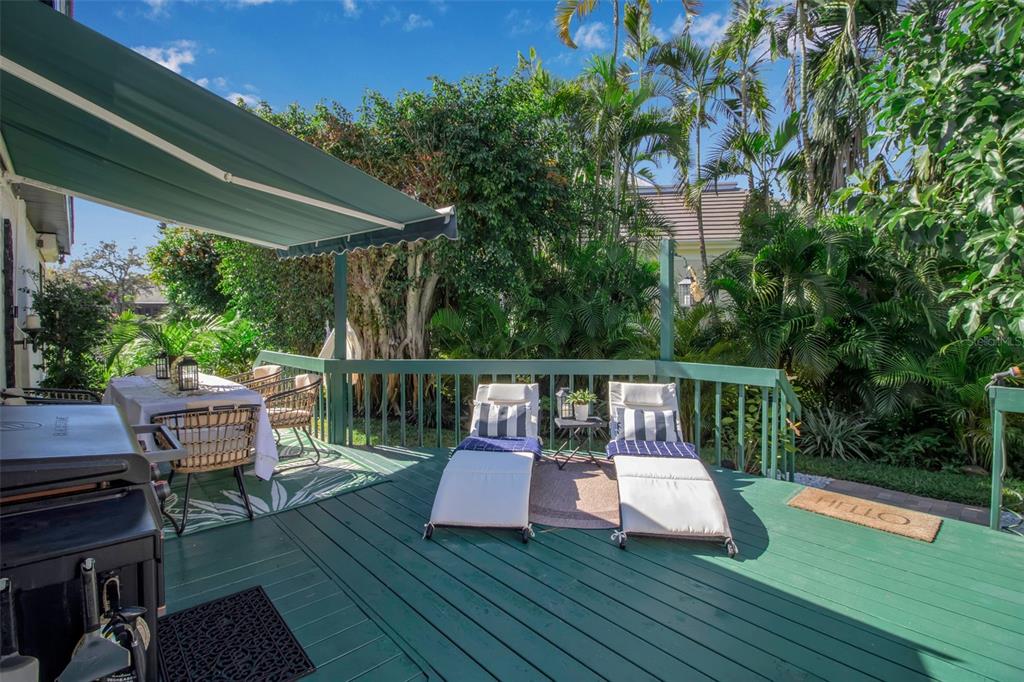 17 Bayhead Lane Osprey, FL 34229 - Photo 30 of 37 a view of a chairs and table on the wooden deck