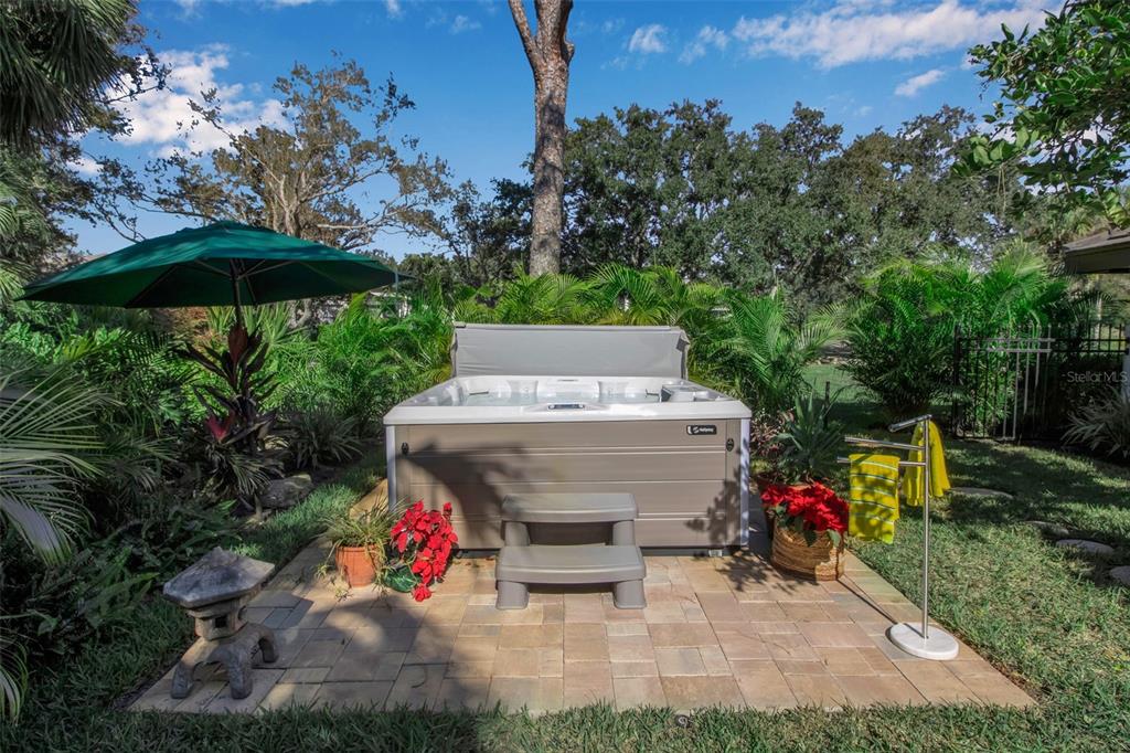 17 Bayhead Lane Osprey, FL 34229 - Photo 32 of 37 an outdoor space with furniture and umbrella
