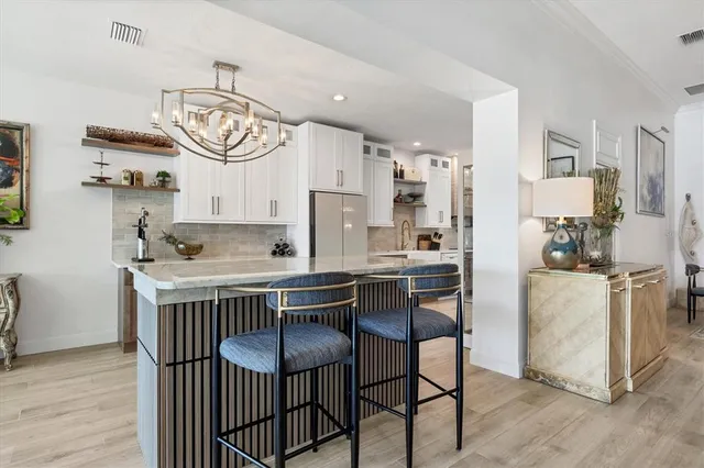 a kitchen with a table chairs and a stove