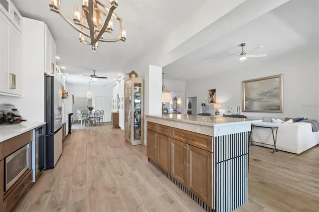 a kitchen with kitchen island granite countertop lots of counter top space and stainless steel appliances