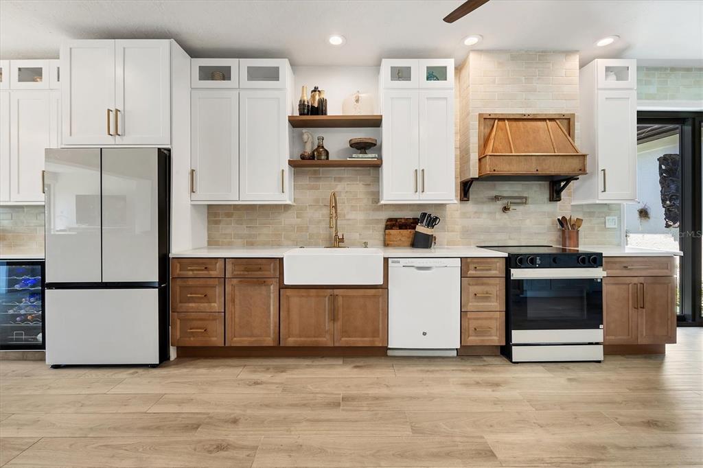 17 Bayhead Lane Osprey, FL 34229 - Photo 7 of 37 a kitchen with stainless steel appliances granite countertop a refrigerator a stove and a sink