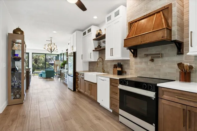 a kitchen with granite countertop wooden floors and stainless steel appliances