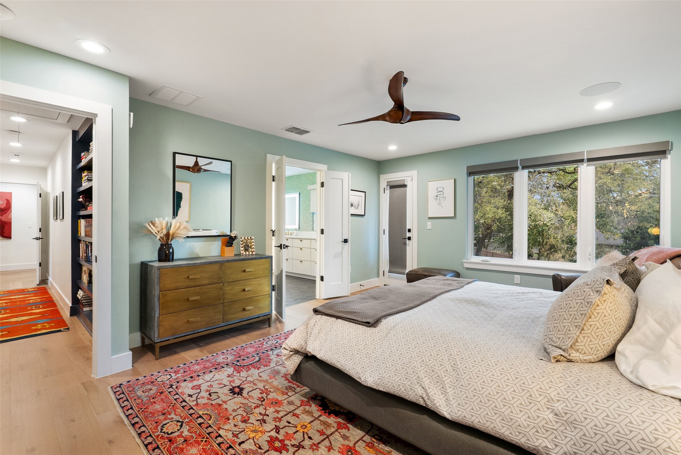 3302 Cherry Tree Circle Austin, TX 78731 - Photo 16 of 37 a bedroom with a large bed and wooden floor