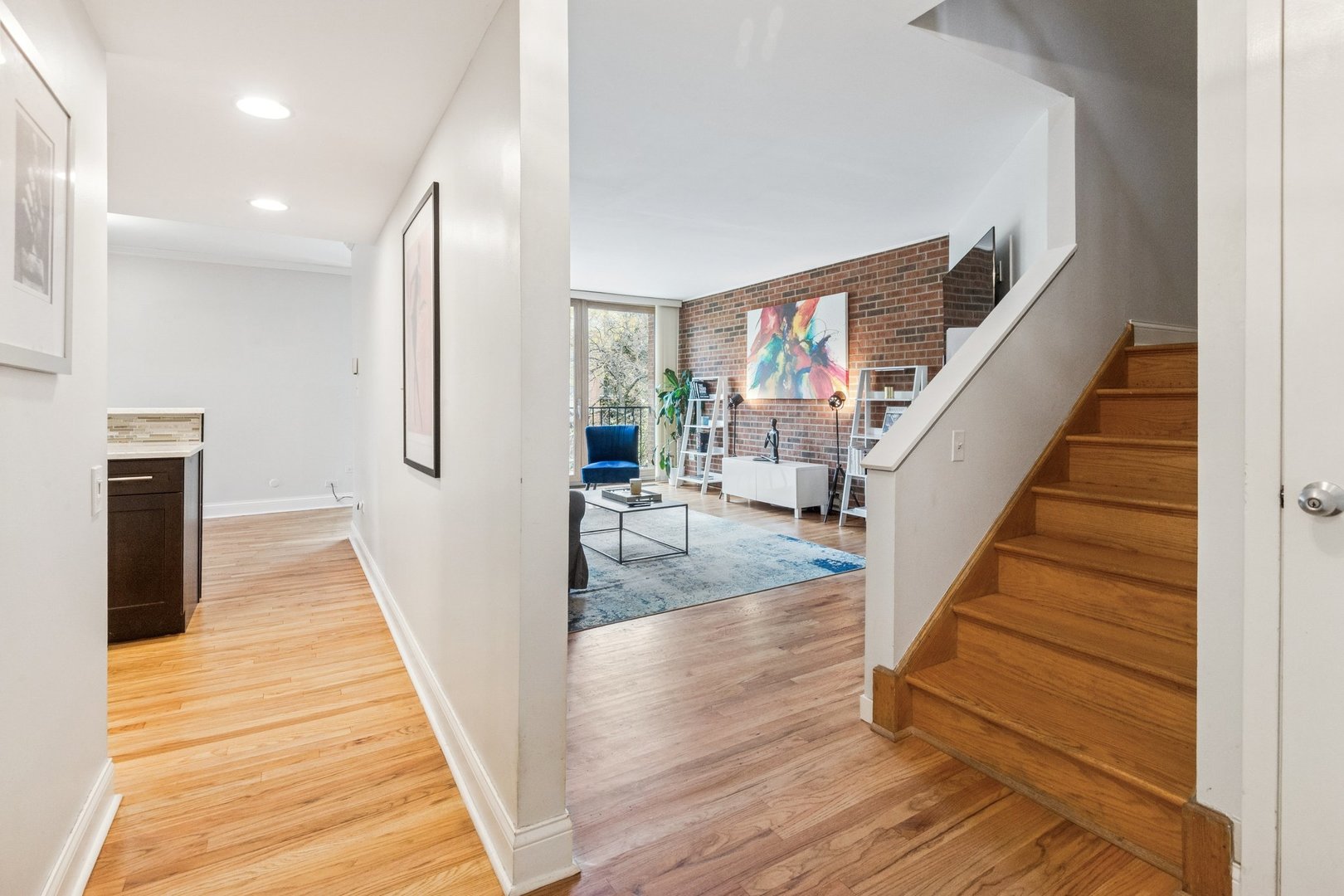 429 West Grant Place, Unit D Chicago, IL 60614 - Photo 2 of 20 a view of a hallway with wooden floor and staircase