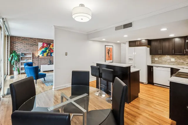 a living room with furniture a dining table and kitchen view