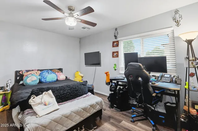 a bedroom with a bed and a flat screen tv