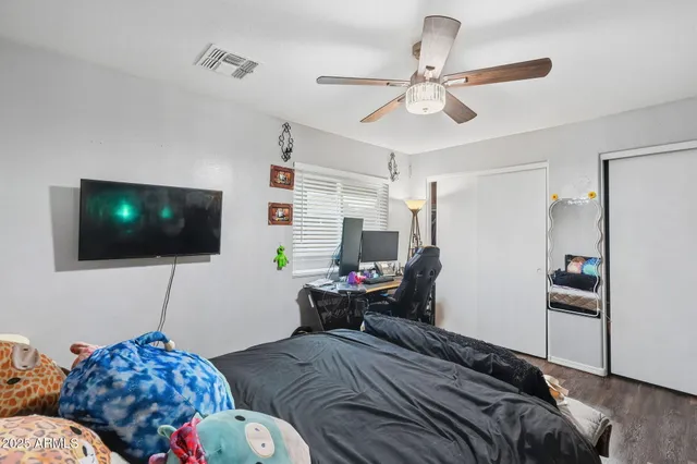 a bedroom with a bed and a flat screen tv