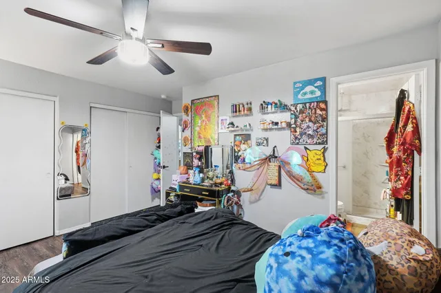 a bedroom with a bed closet and a window