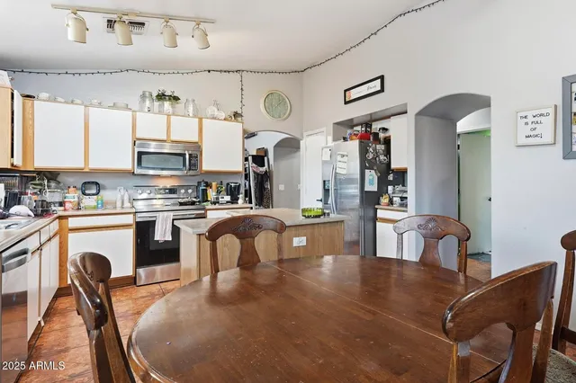 a kitchen with stainless steel appliances granite countertop a sink a stove and cabinets
