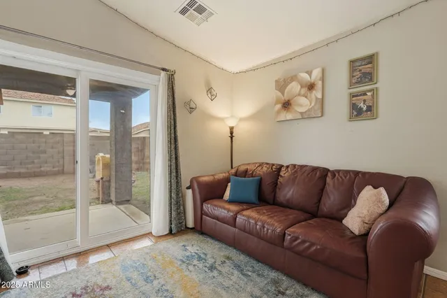 a living room with furniture and a glass door