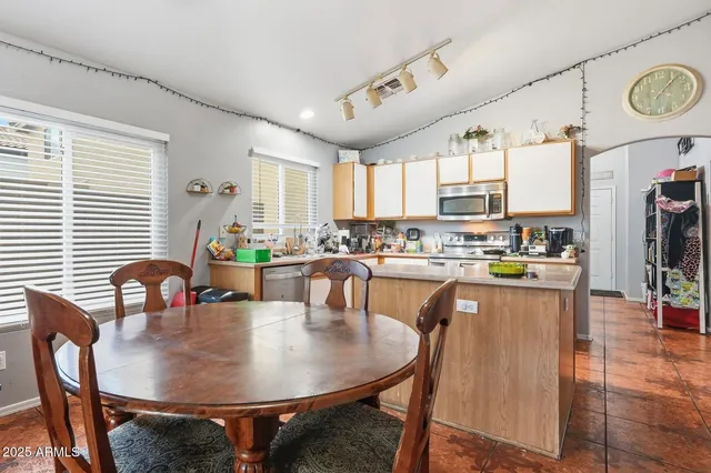 a dining table with chairs and window